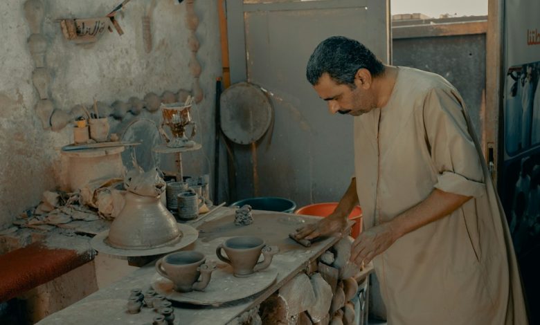 Artisan shaping a ceramic vessel by hand