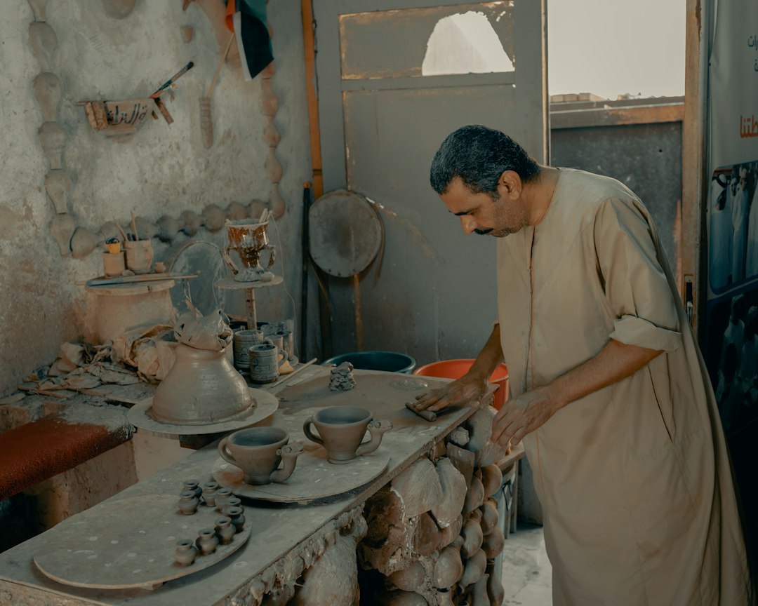 Artisan shaping a ceramic vessel by hand
