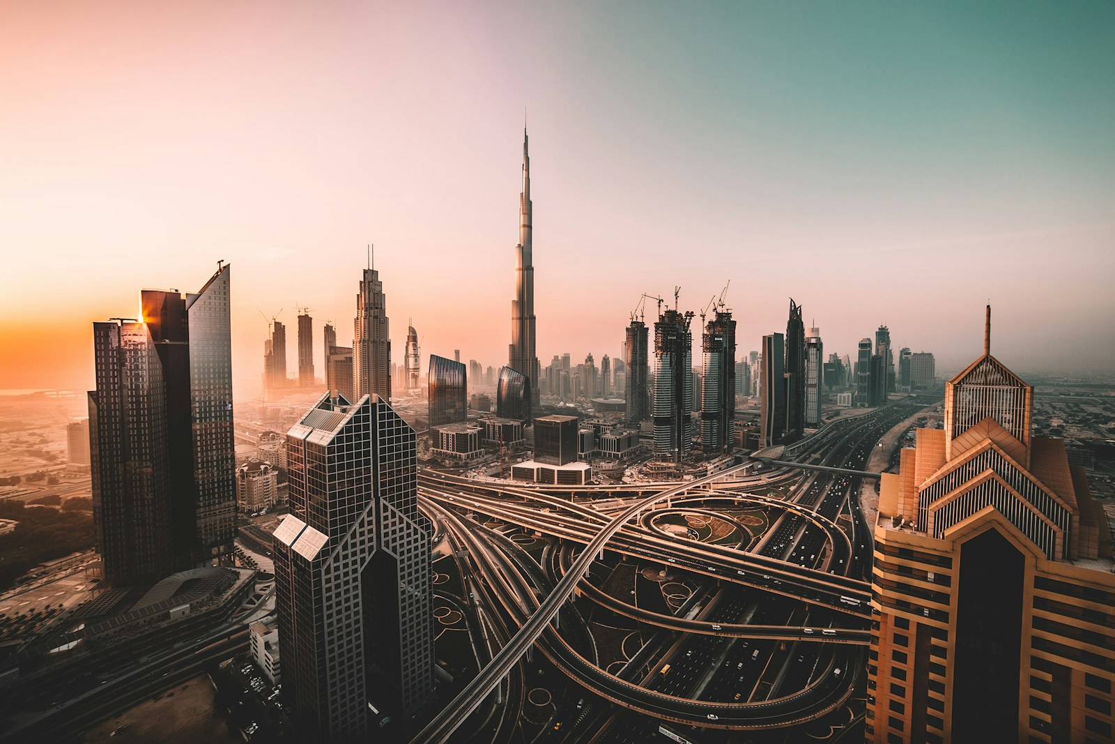 Downtown Dubai skyline and Burj Khalifa at sunrise.