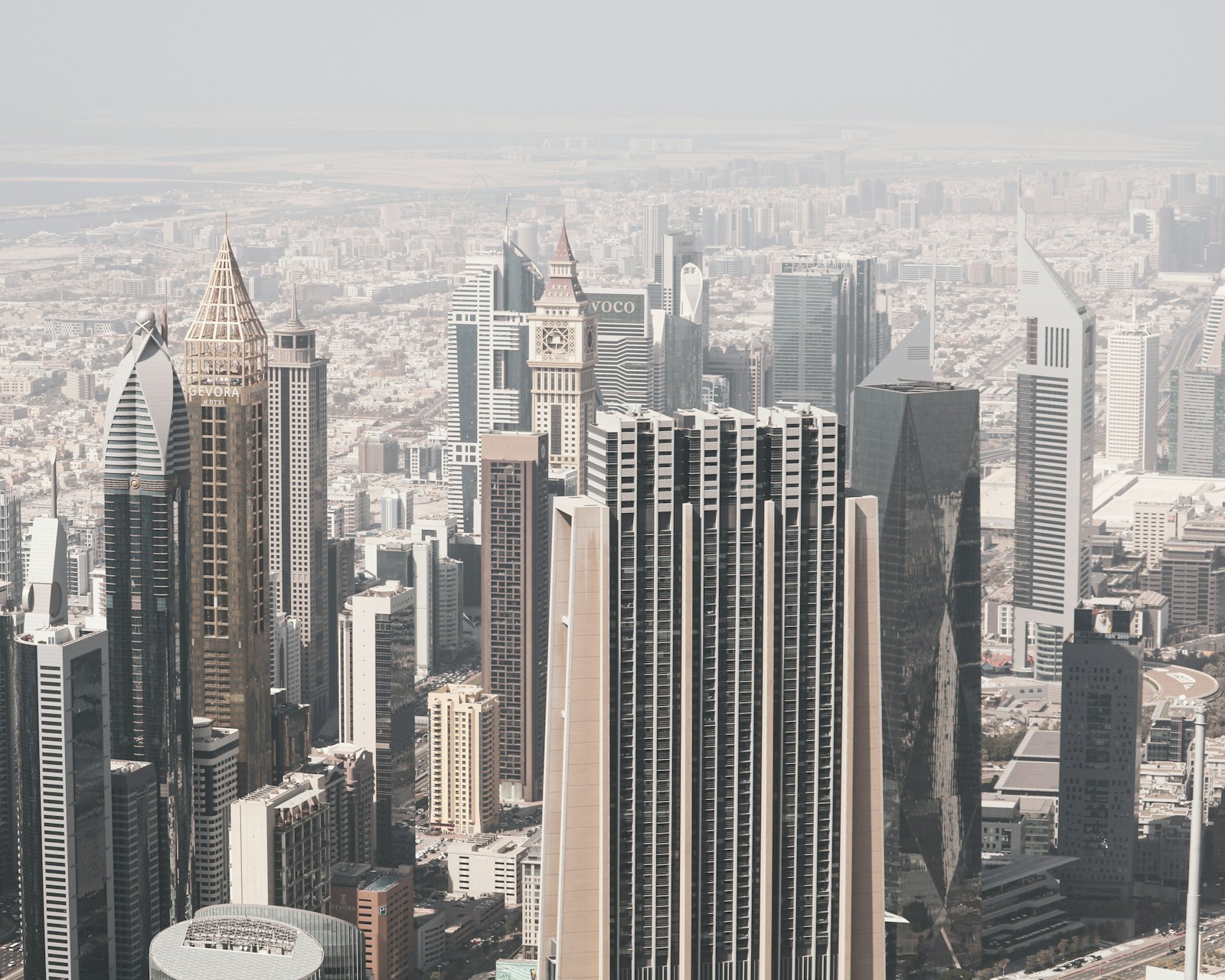 Dubai financial district skyline in hazy daylight.