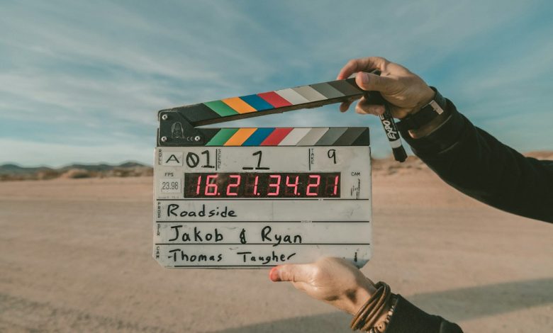 Film clapperboard held in front of a camera crew