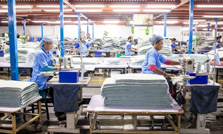 Workers sewing textiles inside a large garment factory