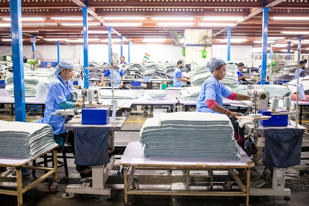 Workers sewing textiles inside a large garment factory