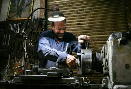 Machinist operating equipment inside an industrial workshop