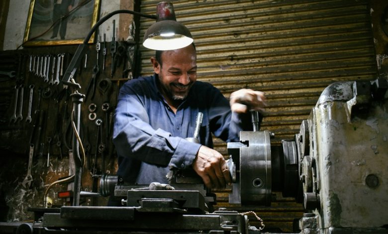 Machinist operating equipment inside an industrial workshop