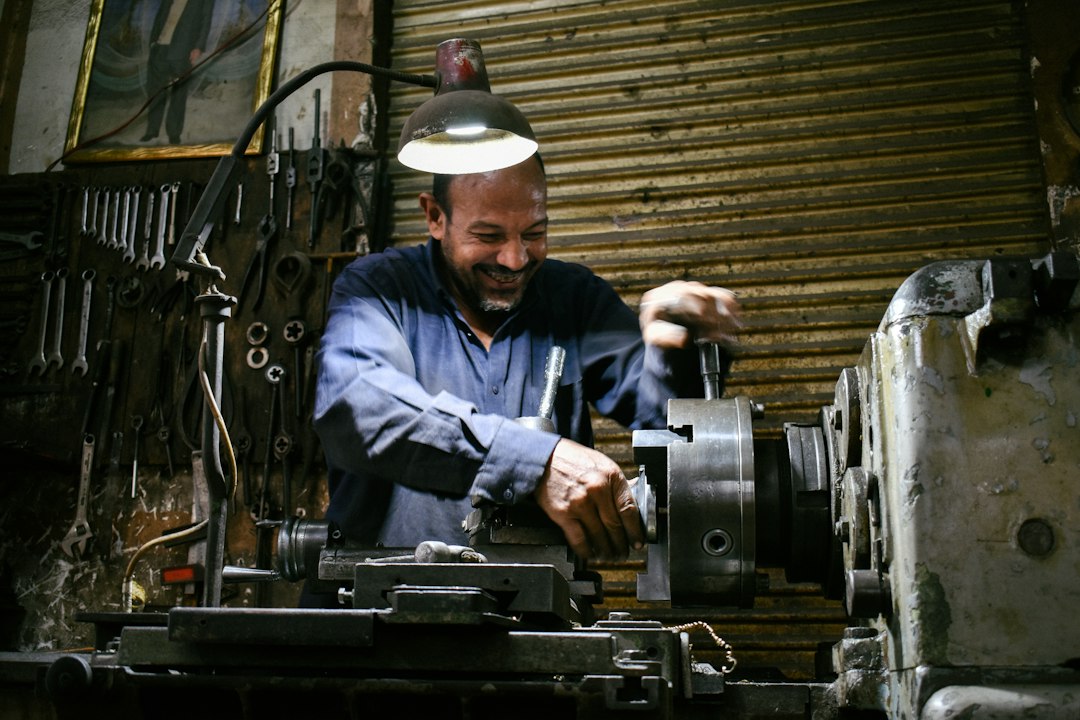 Machinist operating equipment inside an industrial workshop