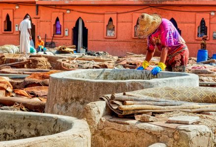 Artisan working with leather at a traditional Moroccan tannery