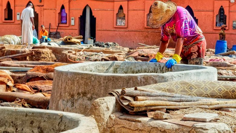 Artisan working with leather at a traditional Moroccan tannery