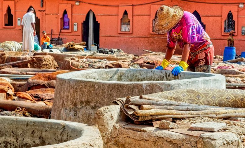 Artisan working with leather at a traditional Moroccan tannery