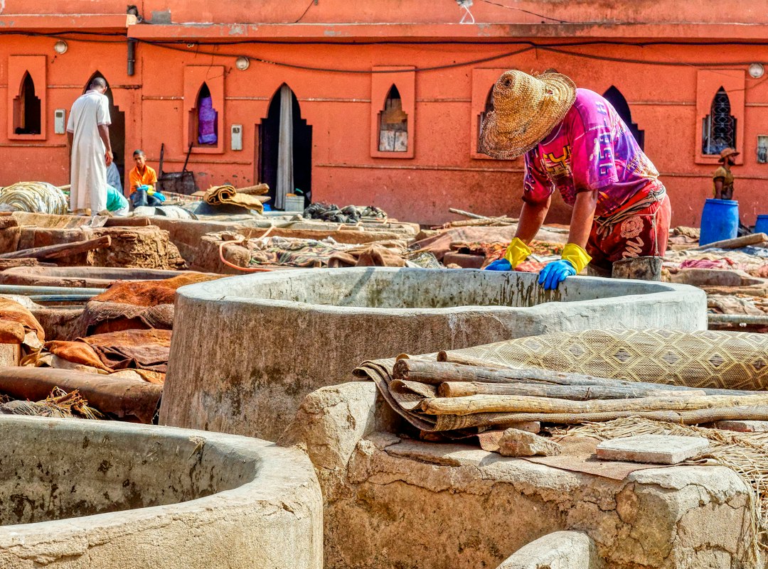Artisan working with leather at a traditional Moroccan tannery