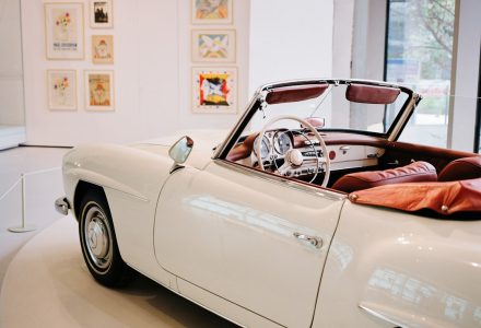 A classic luxury car displayed in a museum setting illustrating Qatar’s automotive culture