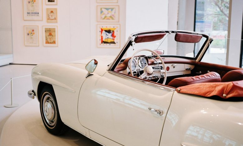 A classic luxury car displayed in a museum setting illustrating Qatar’s automotive culture