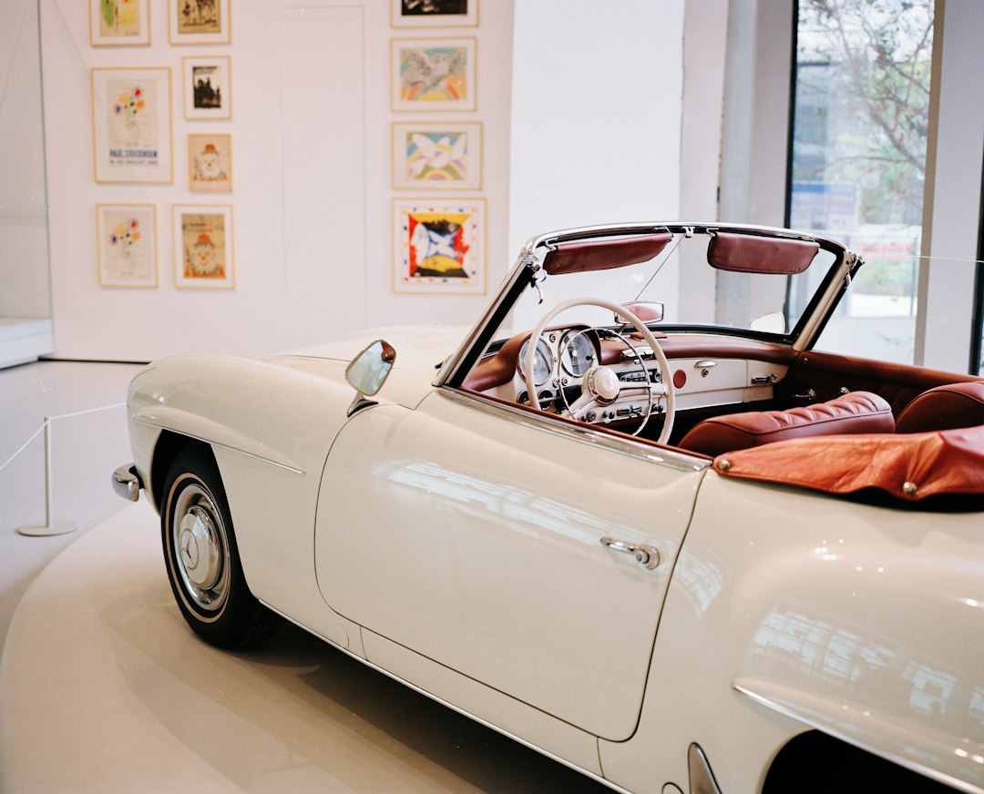 A classic luxury car displayed in a museum setting illustrating Qatar’s automotive culture