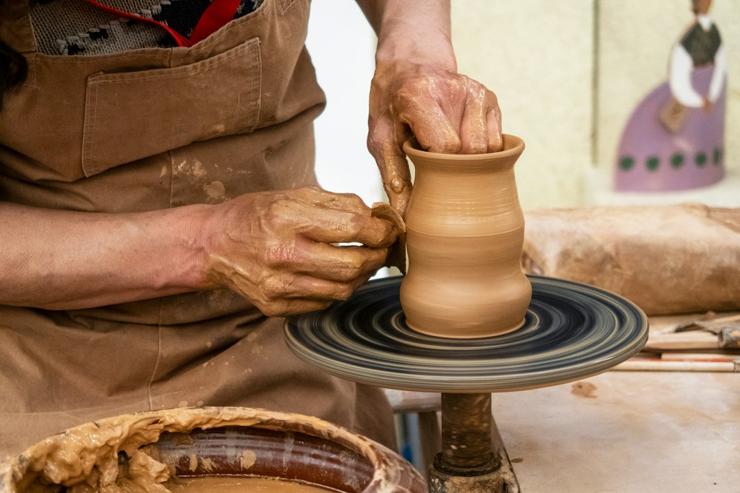 Hands shaping clay on a pottery wheel illustrating Tunisia’s women-led craft and design economy